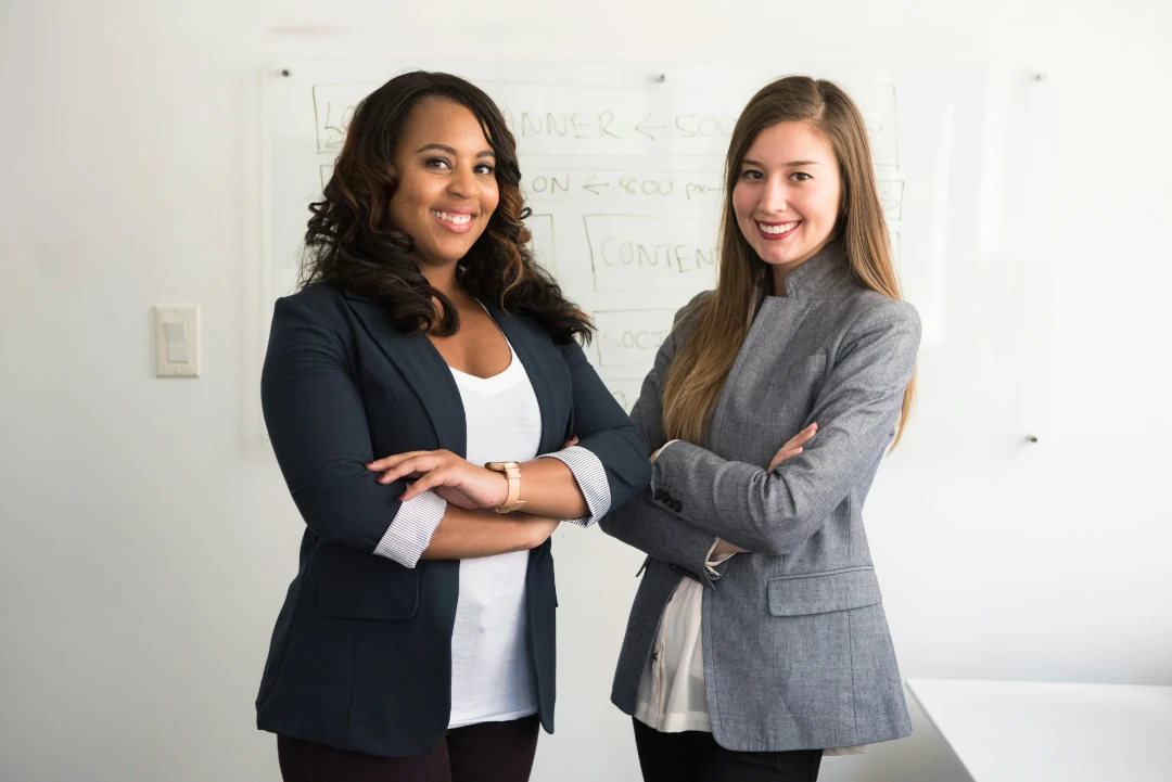 Two confident salespeople are looking at the audience.